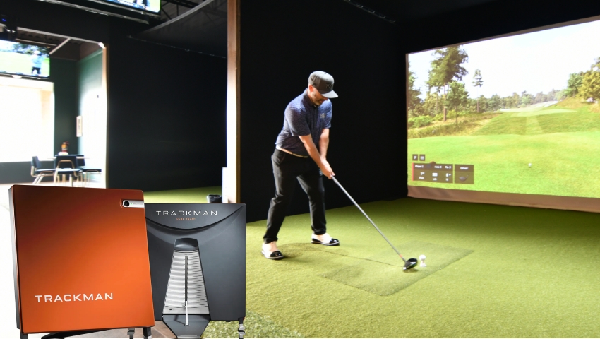 Man using a golf simulator to practice his swing